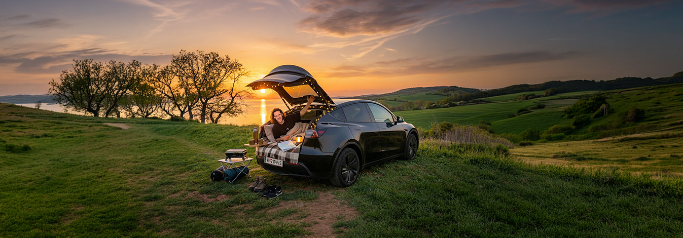 Joel car camping in his Tesla at sunset
